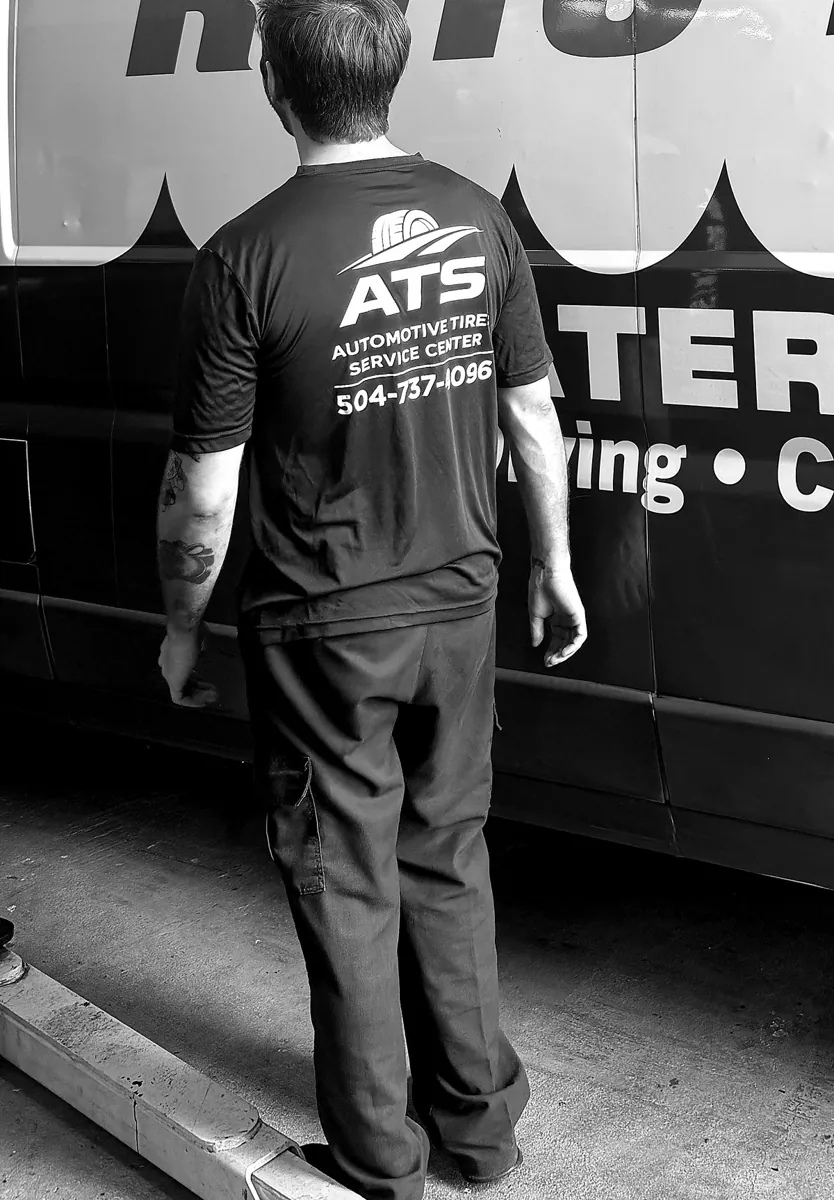 ATS Auto Repair technician on the shop floor in an ATS Auto Repair shirt