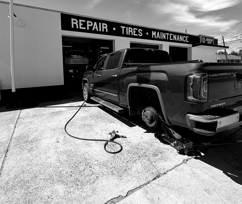 GMC Sierra brake and tire work at ATS Auto Repair storefront on Jefferson Hwy